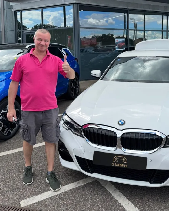 A customer giving a thumbs up beside his new BMW 3 Series