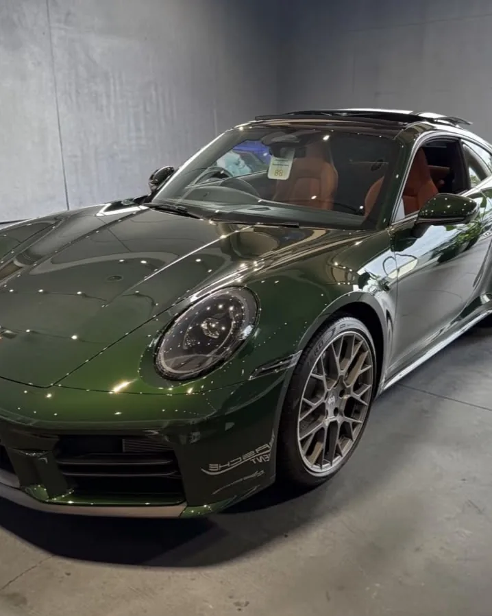 Green Porsche 911 in a showroom