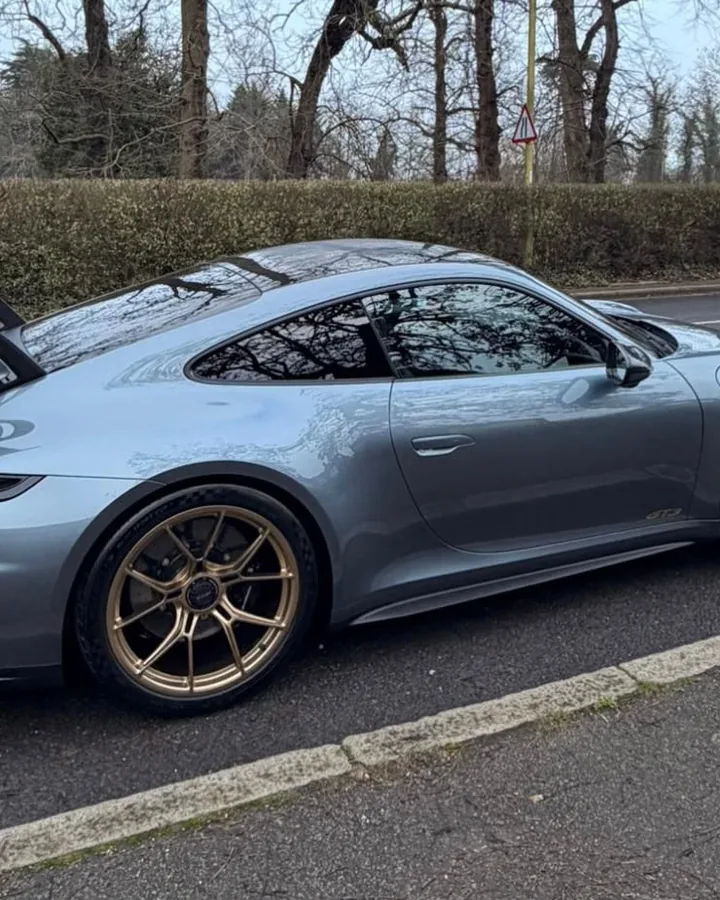 Rear of a grey Porsche 911 GT3, its wing up