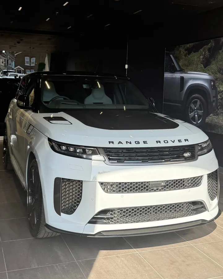 White Range Rover Sport SV with a black bonnet, in a showroom
