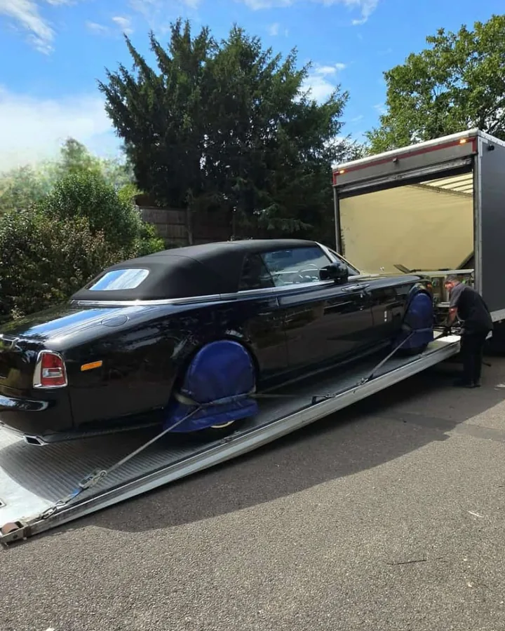 Black Rolls-Royce on a transporter, ready for delivery